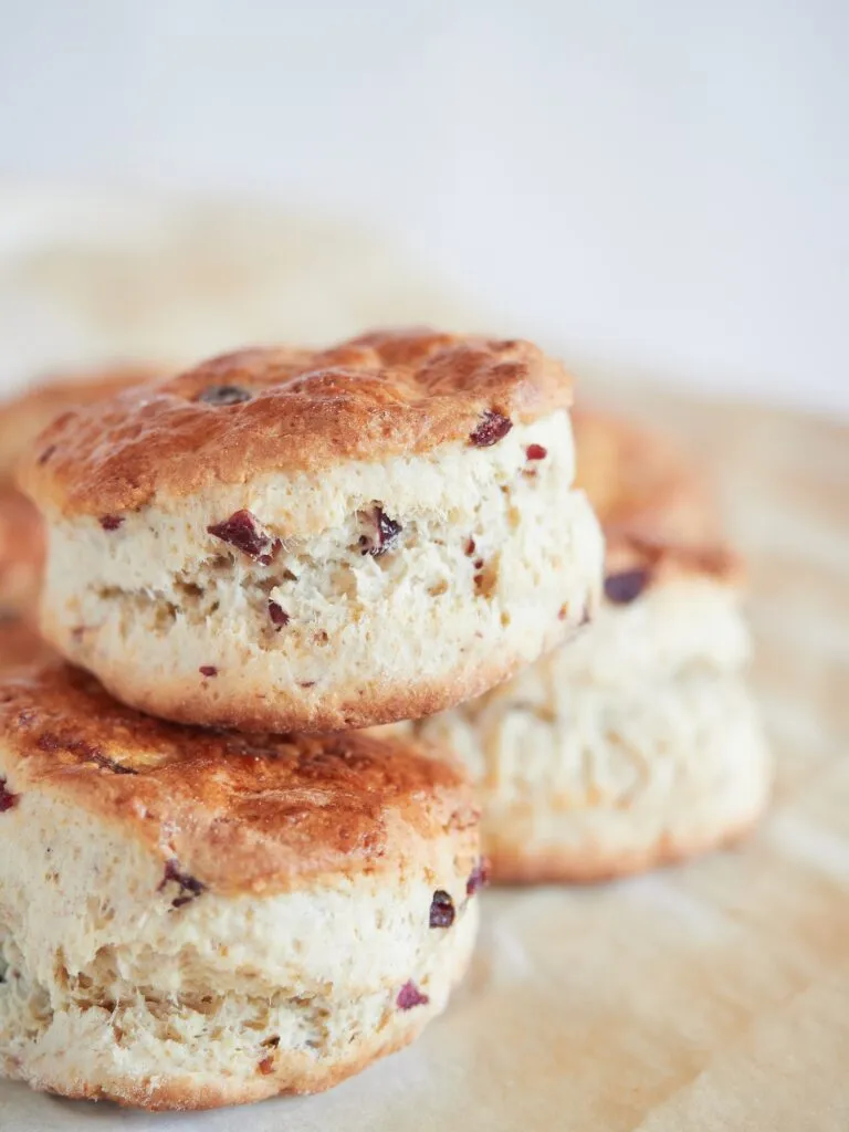 Scons with dried cranberry pieces on baking paper.